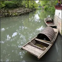 Small wooden boat moored along a canal in the Humble Administrator’s Garden