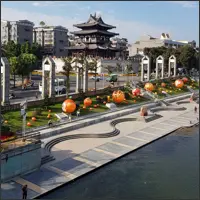Guilin's riverside promenade with traditional architecture and modern buildings beyond.